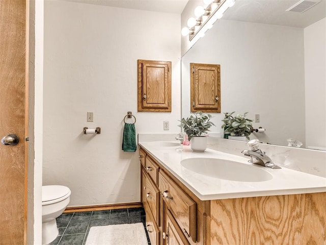 3130 SW 124th St, Oklahoma City, OK 73170 - full bath with double vanity, toilet, tile patterned flooring, and baseboards