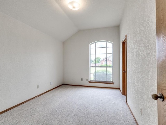 3130 SW 124th St, Oklahoma City, OK 73170 - unfurnished room featuring light colored carpet, lofted ceiling, a textured wall, and baseboards