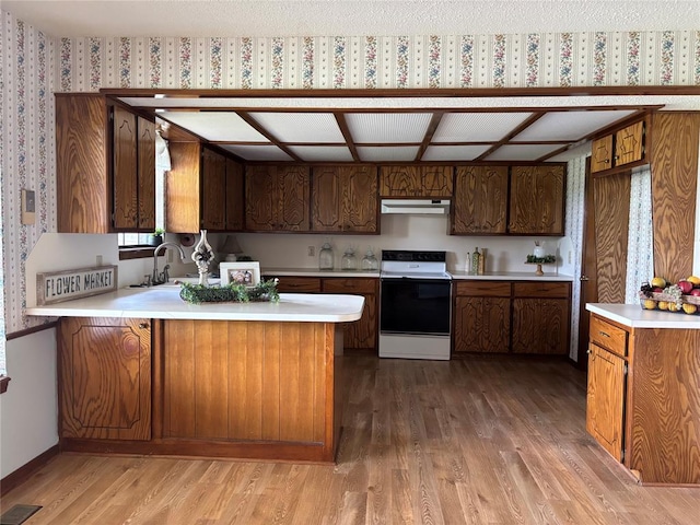425 W Crooked Branch Way, Mustang, OK 73064 - kitchen featuring white range with electric cooktop, under cabinet range hood, light wood-type flooring, light countertops, and wallpapered walls