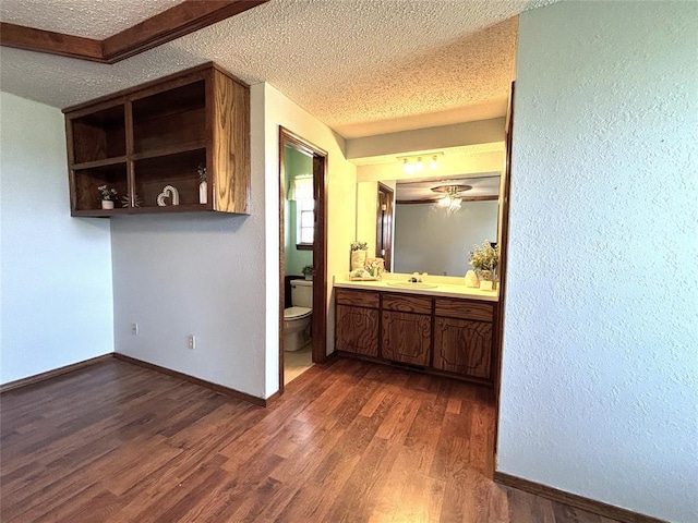 425 W Crooked Branch Way, Mustang, OK 73064 - bathroom featuring a textured ceiling, vanity, wood finished floors, and a textured wall