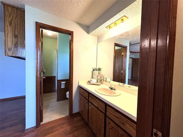 425 W Crooked Branch Way, Mustang, OK 73064 - bathroom with wood finished floors, vanity, and a textured ceiling