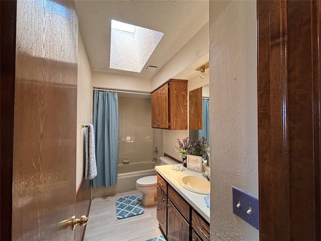 425 W Crooked Branch Way, Mustang, OK 73064 - bathroom with a skylight, vanity, a textured wall, shower / bath combo, and a textured ceiling