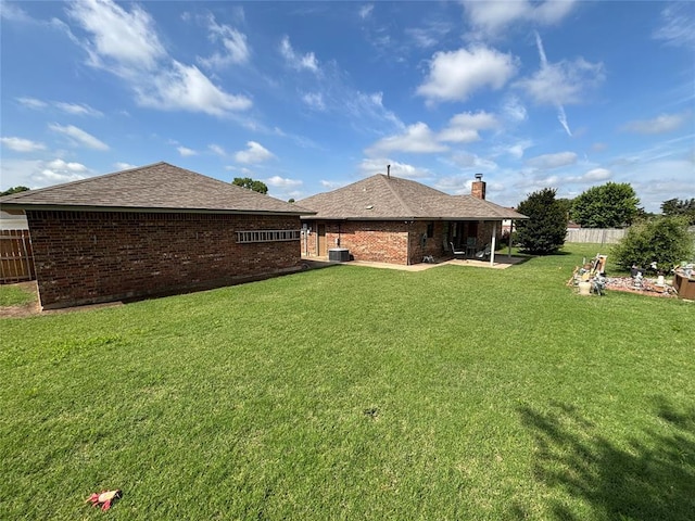 425 W Crooked Branch Way, Mustang, OK 73064 - back of house with brick siding, a chimney, roof with shingles, and a patio