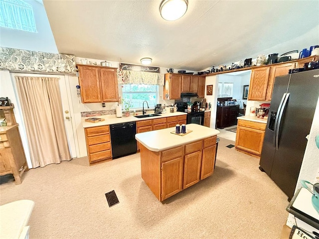 305 N Greer Ave, Duke, OK 73532 - kitchen featuring black appliances, a sink, a center island, light countertops, and vaulted ceiling