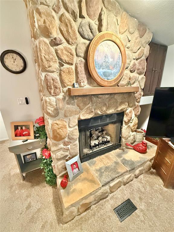 305 N Greer Ave, Duke, OK 73532 - carpeted living room with a fireplace