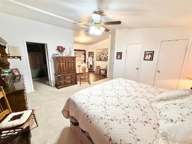 305 N Greer Ave, Duke, OK 73532 - bedroom with light colored carpet, vaulted ceiling, a ceiling fan, and ensuite bath