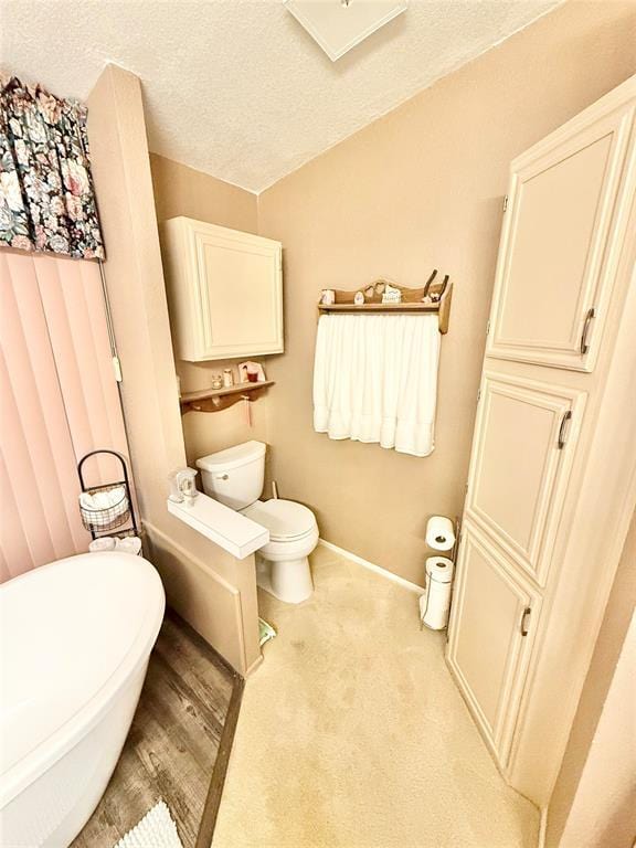 305 N Greer Ave, Duke, OK 73532 - bathroom featuring toilet, a textured ceiling, and baseboards