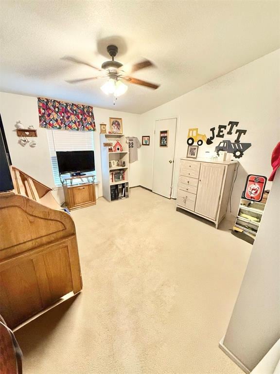 305 N Greer Ave, Duke, OK 73532 - living area featuring a ceiling fan, light colored carpet, and a textured ceiling