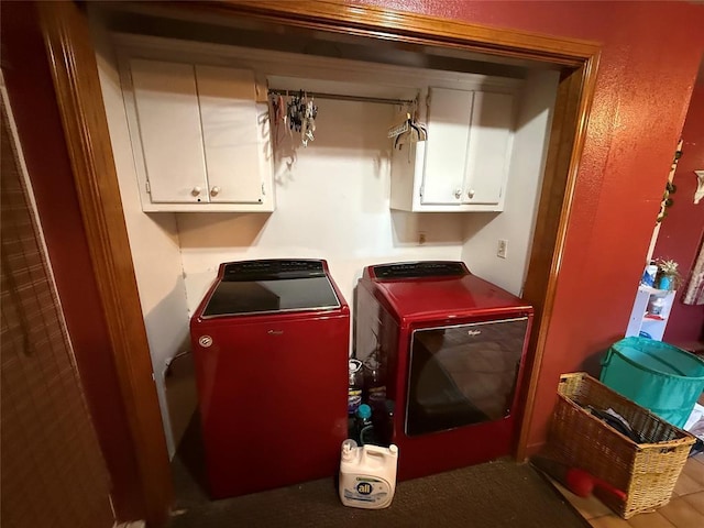 laundry area with independent washer and dryer and cabinet space