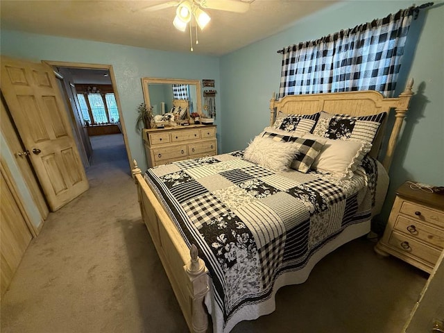 bedroom featuring light carpet and ceiling fan