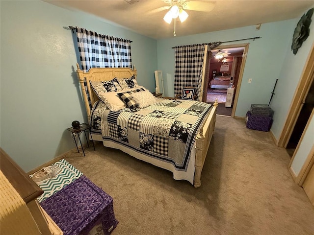 bedroom with carpet, a ceiling fan, and baseboards