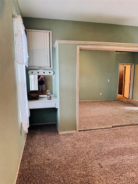 unfurnished bedroom featuring carpet flooring and baseboards