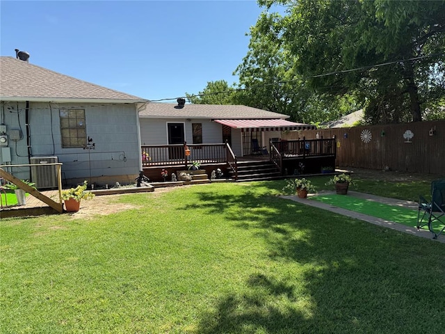 view of yard with a wooden deck and central AC