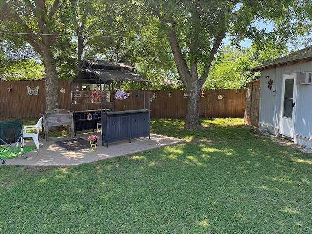 view of yard with a patio and a wall unit AC