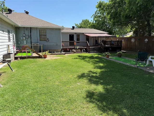 view of yard with a deck and central AC unit