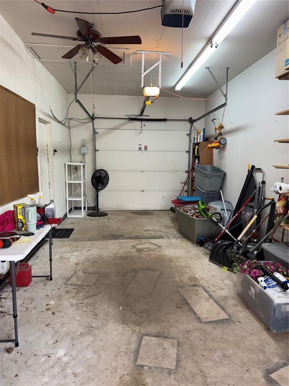 garage featuring a garage door opener and a ceiling fan
