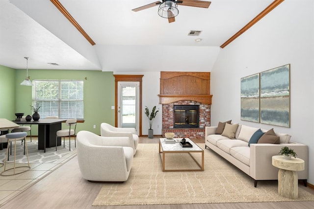 11014 Madison Ave, Midwest City, OK 73130 - living room with ceiling fan, light wood-style floors, vaulted ceiling, and a brick fireplace