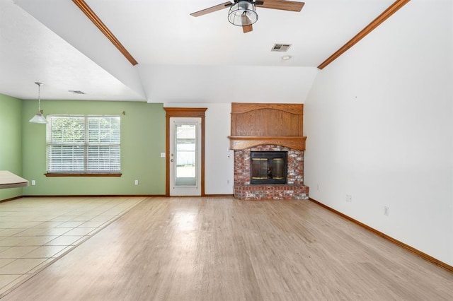 11014 Madison Ave, Midwest City, OK 73130 - unfurnished living room featuring a ceiling fan, baseboards, wood finished floors, a fireplace, and lofted ceiling