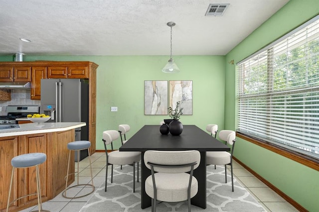 11014 Madison Ave, Midwest City, OK 73130 - dining room featuring light tile patterned floors and baseboards