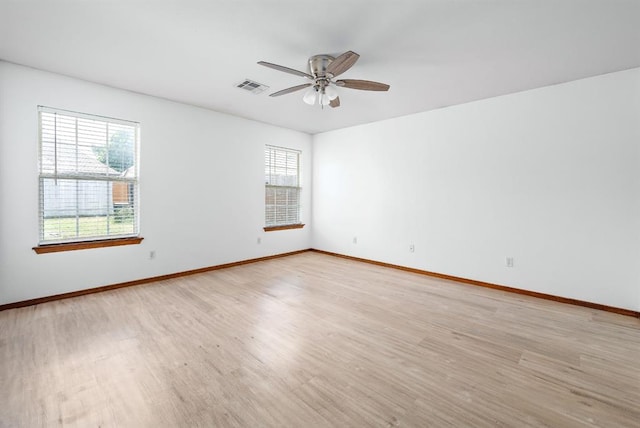 11014 Madison Ave, Midwest City, OK 73130 - spare room with light wood-type flooring, a ceiling fan, and baseboards
