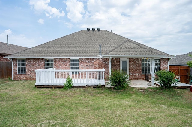 11014 Madison Ave, Midwest City, OK 73130 - back of property featuring a shingled roof, brick siding, a deck, and a patio area