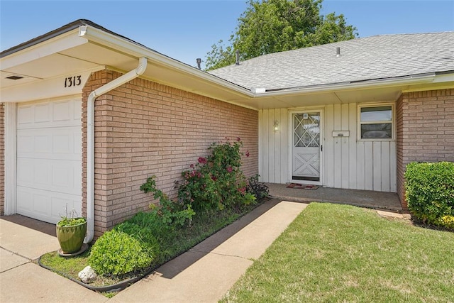1313 SW 69th St, Oklahoma City, OK 73159 - doorway to property with brick siding, a garage, a shingled roof, and a lawn