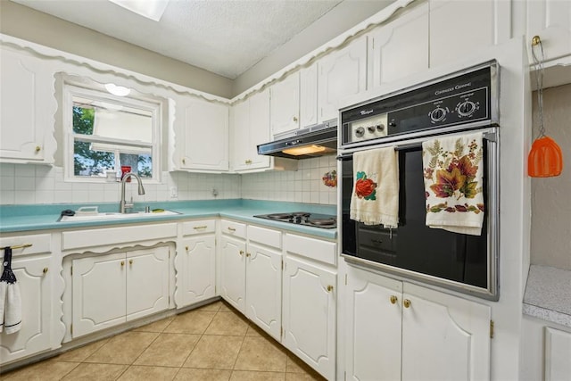 1313 SW 69th St, Oklahoma City, OK 73159 - kitchen featuring black appliances, a sink, light tile patterned floors, tasteful backsplash, and a textured ceiling