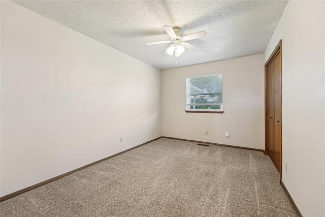 1313 SW 69th St, Oklahoma City, OK 73159 - spare room with light carpet, a textured ceiling, ceiling fan, and baseboards