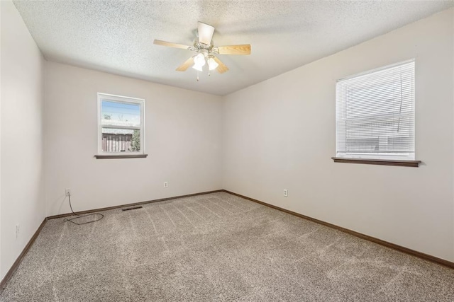 1313 SW 69th St, Oklahoma City, OK 73159 - spare room with light carpet, ceiling fan, baseboards, and a textured ceiling