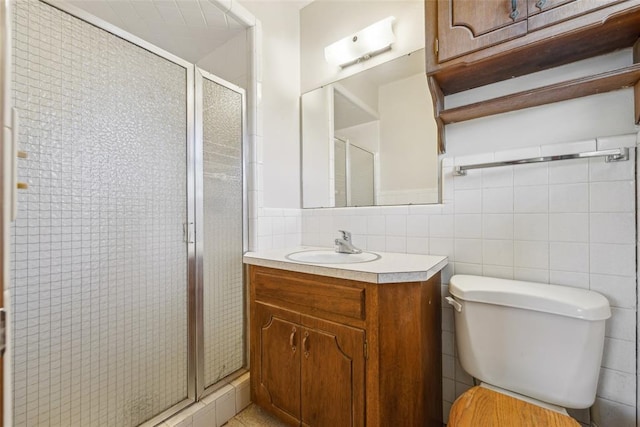 1313 SW 69th St, Oklahoma City, OK 73159 - full bathroom with toilet, vanity, a stall shower, and tile walls