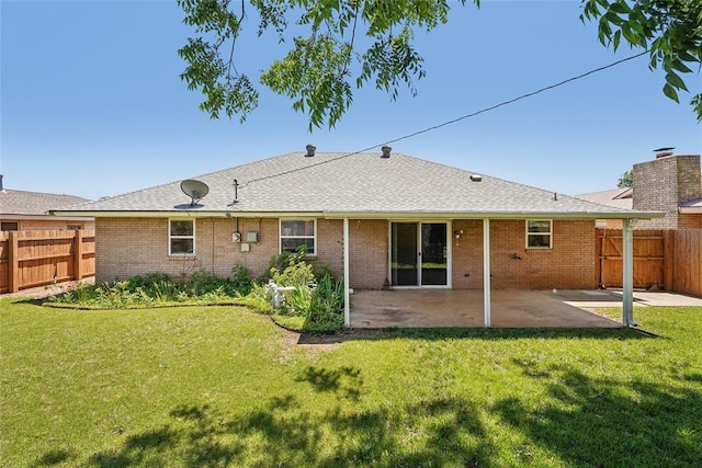 1313 SW 69th St, Oklahoma City, OK 73159 - back of property with a patio, brick siding, and a shingled roof
