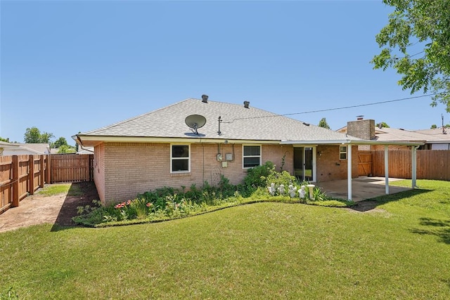 1313 SW 69th St, Oklahoma City, OK 73159 - rear view of house with brick siding, a patio, and roof with shingles