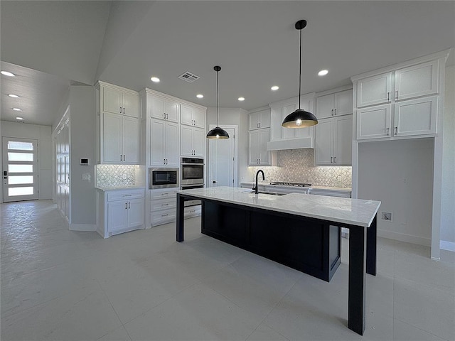 7217 NW 154th St, Edmond, OK 73013 - kitchen featuring stainless steel appliances, a sink, recessed lighting, tasteful backsplash, and white cabinetry