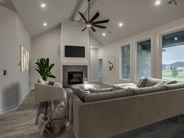 7217 NW 154th St, Edmond, OK 73013 - living room with ceiling fan, wood finished floors, baseboards, a glass covered fireplace, and beam ceiling