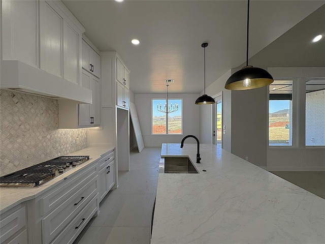 7217 NW 154th St, Edmond, OK 73013 - kitchen featuring stainless steel gas stovetop, a sink, decorative backsplash, light stone counters, and recessed lighting