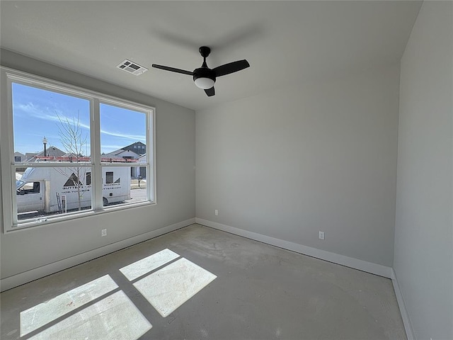7217 NW 154th St, Edmond, OK 73013 - unfurnished room featuring unfinished concrete floors, a ceiling fan, and baseboards