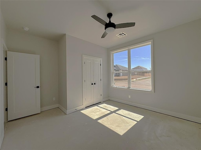 7217 NW 154th St, Edmond, OK 73013 - unfurnished bedroom with concrete floors, baseboards, a ceiling fan, and a closet