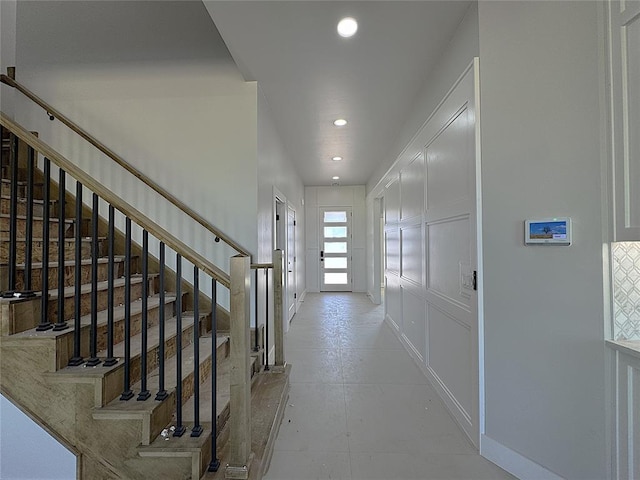 7217 NW 154th St, Edmond, OK 73013 - hall with stairs, recessed lighting, baseboards, and a decorative wall