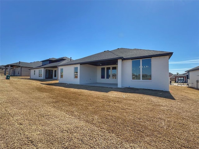 7217 NW 154th St, Edmond, OK 73013 - rear view of house with a patio and a lawn