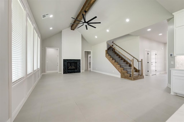 7217 NW 154th St, Edmond, OK 73013 - unfurnished living room with beam ceiling, stairs, plenty of natural light, a ceiling fan, and a high end fireplace
