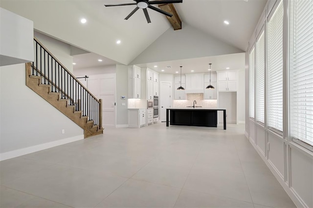 7217 NW 154th St, Edmond, OK 73013 - unfurnished living room with beam ceiling, ceiling fan, stairs, high vaulted ceiling, and healthy amount of natural light