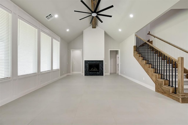 7217 NW 154th St, Edmond, OK 73013 - unfurnished living room with ceiling fan, beam ceiling, stairs, a high end fireplace, and high vaulted ceiling