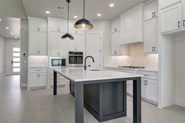 7217 NW 154th St, Edmond, OK 73013 - kitchen with appliances with stainless steel finishes, backsplash, a kitchen bar, light countertops, and recessed lighting