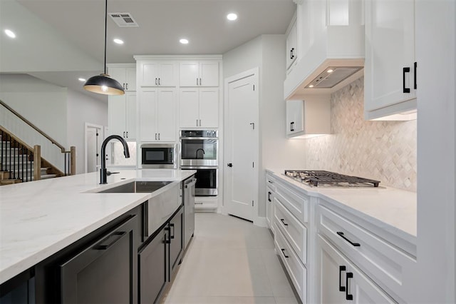 7217 NW 154th St, Edmond, OK 73013 - kitchen featuring stainless steel appliances, custom exhaust hood, recessed lighting, white cabinets, and pendant lighting