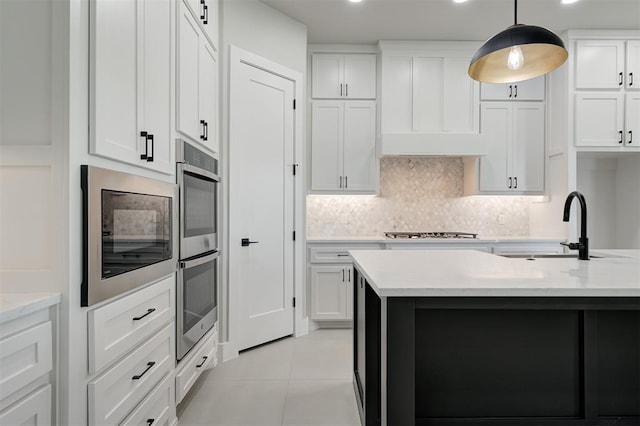 7217 NW 154th St, Edmond, OK 73013 - kitchen with stainless steel appliances, white cabinetry, backsplash, pendant lighting, and light tile patterned flooring