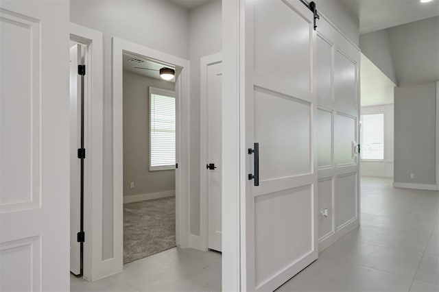7217 NW 154th St, Edmond, OK 73013 - hallway featuring light carpet and a barn door