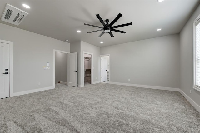 7217 NW 154th St, Edmond, OK 73013 - unfurnished bedroom with recessed lighting, light carpet, a walk in closet, ceiling fan, and multiple windows