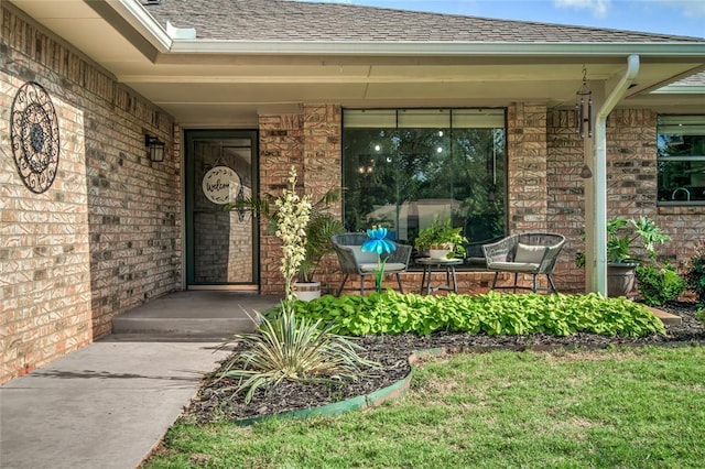 2416 Northwood Ln, Edmond, OK 73013 - property entrance with covered porch, a shingled roof, and brick siding