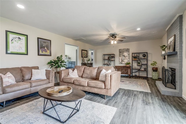2416 Northwood Ln, Edmond, OK 73013 - living room featuring dark wood finished floors, ceiling fan, recessed lighting, a fireplace, and baseboards