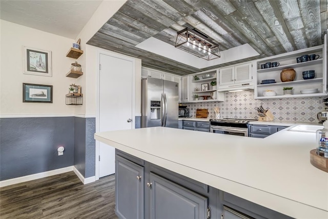 2416 Northwood Ln, Edmond, OK 73013 - kitchen with open shelves, appliances with stainless steel finishes, a sink, dark wood-type flooring, and under cabinet range hood